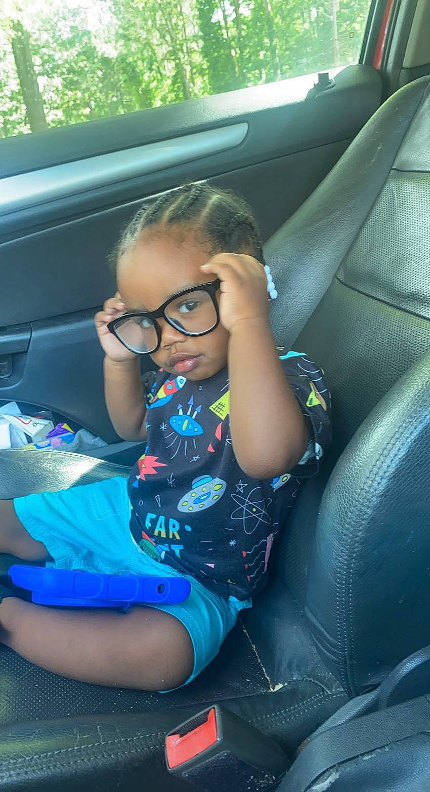 Kiersten is registered to the contest to win money with this photo: auto_part, automotive_design, automotive_exterior, car, car_seat, car_seat_cover, comfort, cool, electric_blue, eyewear, glasses, head_restraint, leisure, motor_vehicle, person, smile, steering_part, thigh, toddler, vehicle_door