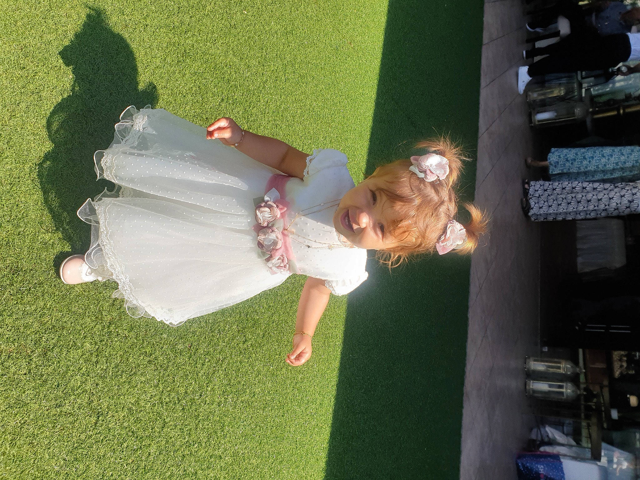 Valentina participe au concours pour gagner de l'argent avec cette photo : bridal_accessory, ceremony, child, dress, event, fun, grass, happy, lawn, leisure, person, plant, smile, toddler, tree, wedding_dress