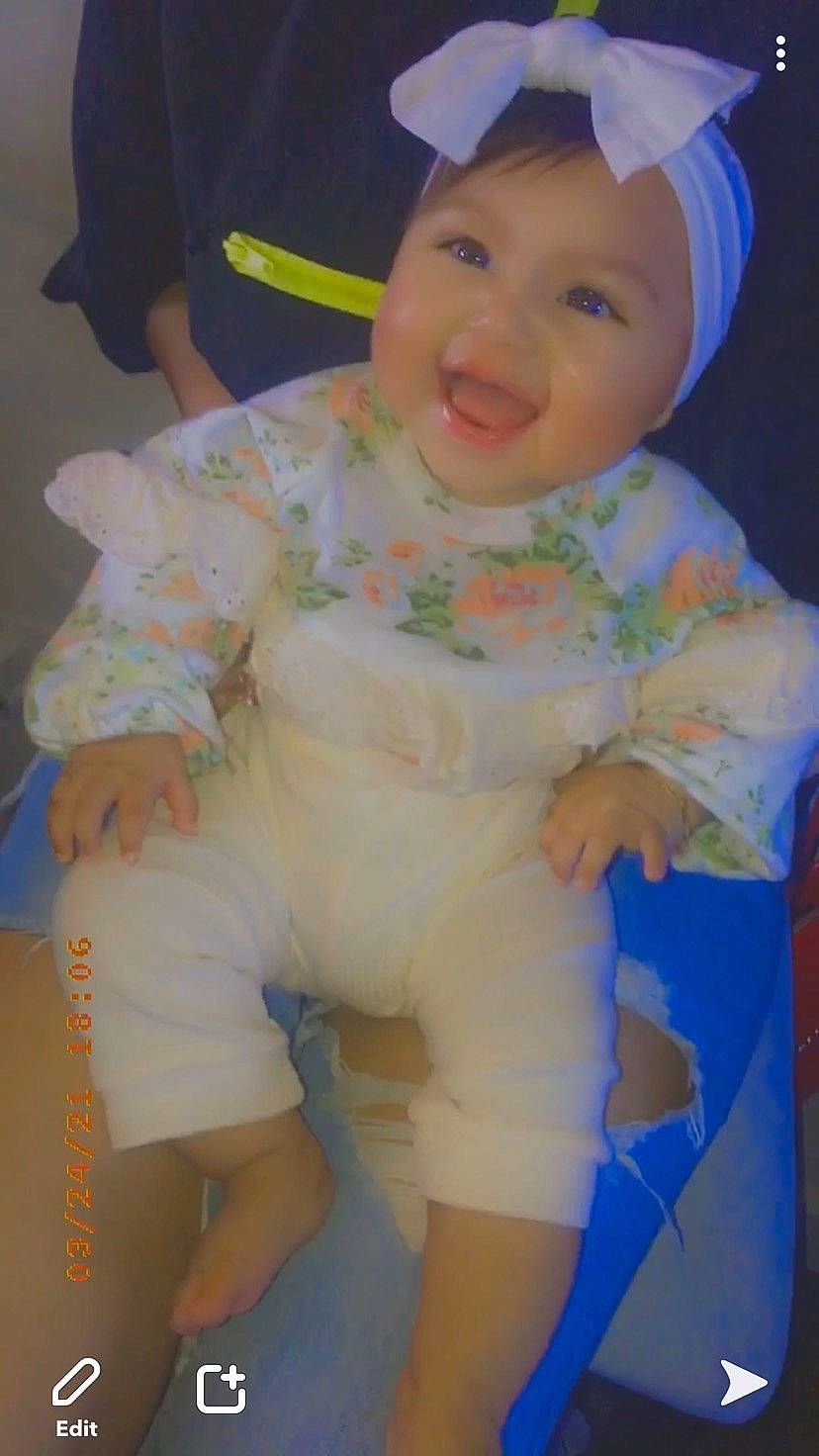 Yzabella is registered to the contest to win money with this photo: baby, baby_toddler_clothing, cheek, child, eye, face, finger, fun, happy, headwear, human_leg, iris, knee, person, pink, skin, sleeve, smile, thigh, thumb