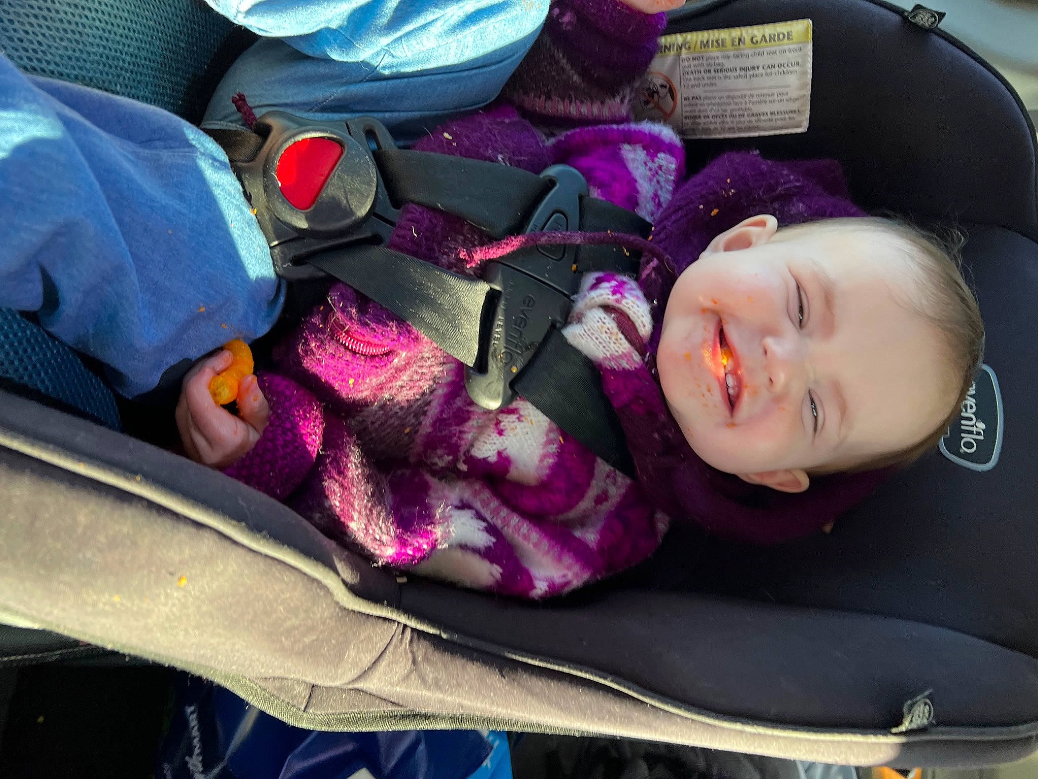 Brenna is registered to the contest to win money with this photo: auto_part, baby, baby_carriage, baby_in_car_seat, baby_products, baby_toddler_clothing, car_seat, child, comfort, joy, lap, magenta, person, purple, sitting, smile, textile, toddler, violet