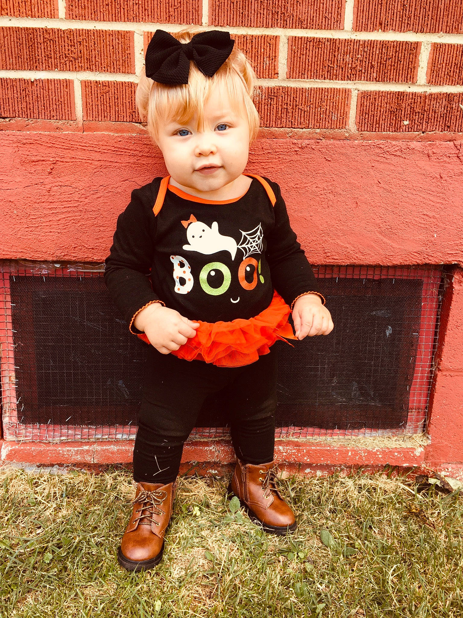 Sienna is registered to the contest to win money with this photo: baby, baby_toddler_clothing, cheek, child, ear, footwear, grass, pattern, person, pumpkin, shoe, skin, sleeve, smile, t_shirt, toddler