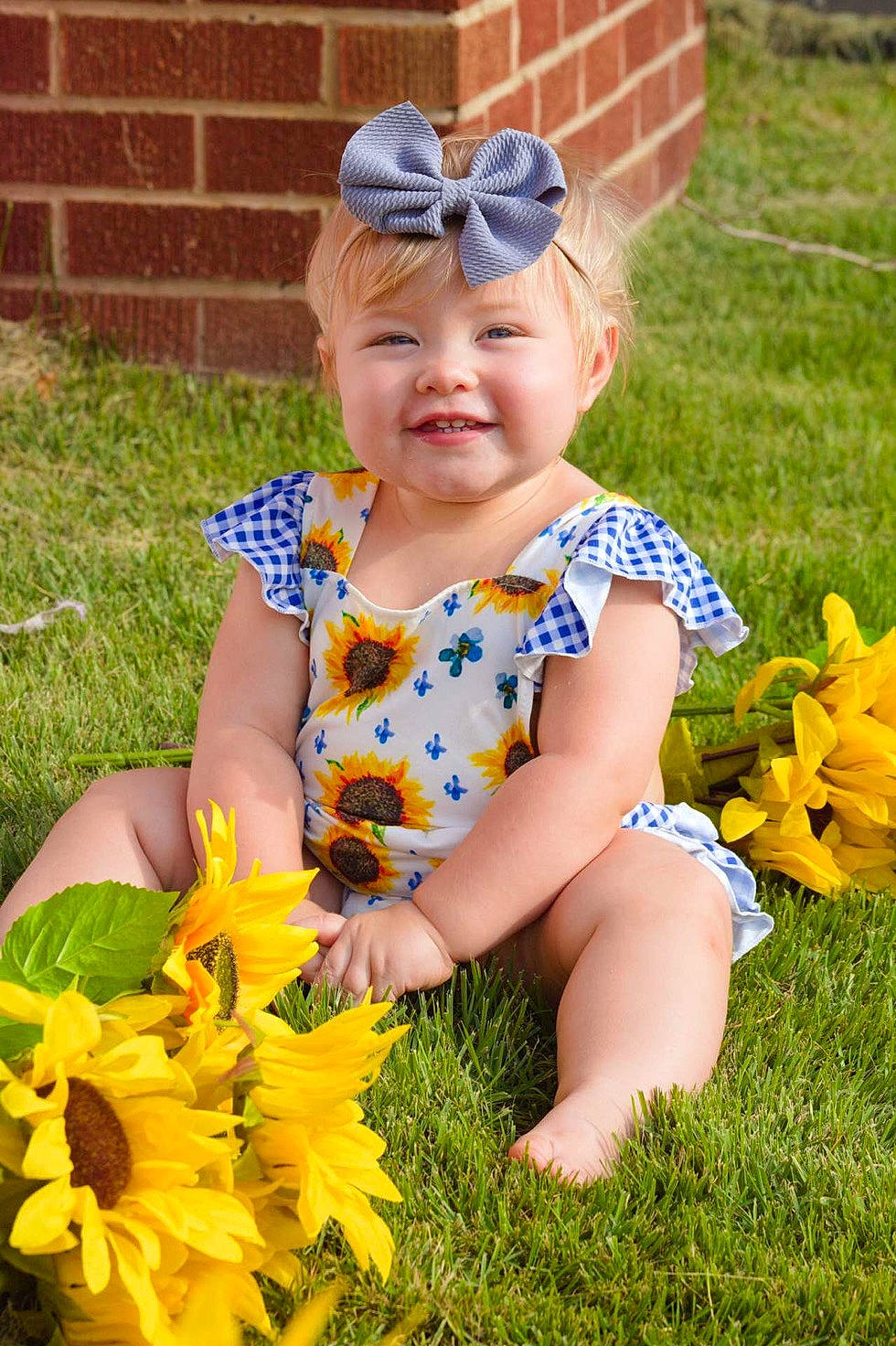 Sienna joined the competition — help win amazing prizes! baby, child, flower, fun, garden, grass, happy, headwear, joy, person, plant, play, smile, spring, summer, sunflower, toddler, wildflower, yard, yellow
