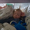 Isaiah is registered to the contest to win money with this photo: bed, bedroom, blanket, blue_toy, child, clothing, cozy, curtains, face, furniture, hair, indoor, nap, pajamas, peaceful, plush_toy, resting, sleeping, soft_lighting, toddler
