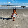 toddler, child, beach, sand, ocean, waves, sky, clouds, sunlight, shadow, swimsuit, person, water, shore, summer, play, vacation, outdoor, nature, fun
