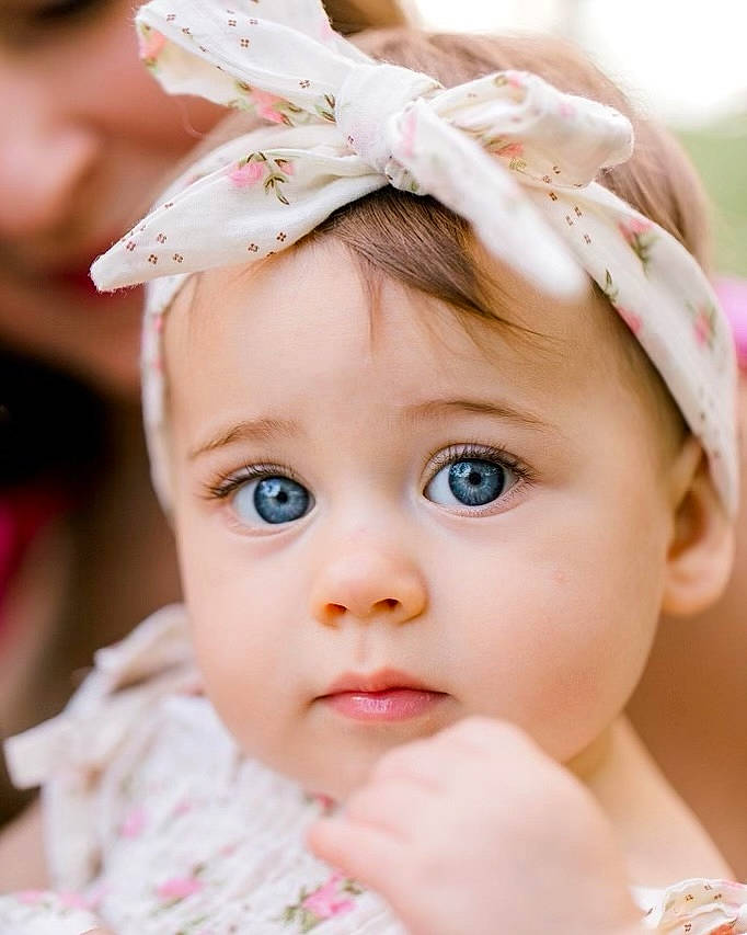 Cassia joined the competition — help win amazing prizes! baby, baby_toddler_clothing, cap, cheek, child, close_up, dress, ear, eyelash, grass, happy, headband, headgear, headpiece, headwear, iris, lip, person, petal, pink