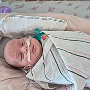 Novalee joined the competition — help win amazing prizes! baby, infant, sleeping, hospital, blanket, pacifier, nasal_tube, bed, pink, floral, soft, wrapped, newborn, face, person, healthcare, resting, quiet, indoors, treatment