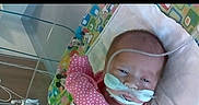Novalee is registered to the contest to win money with this photo: baby, infant, medical_tubes, hospital, baby_seat, pink_clothing, face, newborn, healthcare, child, person, lying_down, equipment, indoors, monitoring, resting, cute, patient, care, small