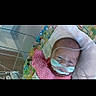 baby, infant, medical_tubes, hospital, baby_seat, pink_clothing, face, newborn, healthcare, child, person, lying_down, equipment, indoors, monitoring, resting, cute, patient, care, small