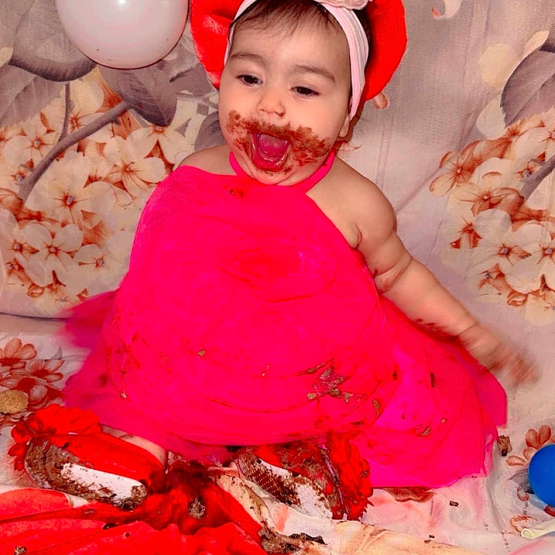 Sofia joined the competition — help win amazing prizes! baby, balloons, birthday, cake, celebration, child, cute, face_paint, flower_backdrop, food, fun, happy, headband, indoor, messy, party, pink_dress, red_flower, sitting, smiling