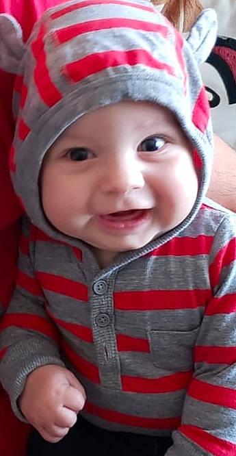 Sami joined the competition — help win amazing prizes! baby, bonnet, cheek, child, chin, cool, eye, face, facial_expression, head, headgear, headwear, knit_cap, laugh, lip, mouth, nose, person, pink, skin