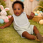 Nahzir is registered to the contest to win money with this photo: baby, child, grass, easter_eggs, plush_bunny, basket, flowers, garland, pastel_colors, spring, smiling, cute, outdoor, festive, holiday, greenery, infant, bib, shorts, shoes