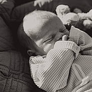 Deklan joined the competition — help win amazing prizes! baby, newborn, infant, sleeping, black_and_white, blanket, clothing, hand, thumb, closeup, portrait, cozy, soft_light, texture, peaceful, resting, cute, young_child, indoors, quiet