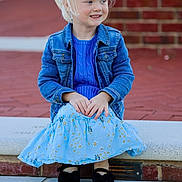 Averiella joined the competition — help win amazing prizes! child, girl, blonde_hair, ponytail, blue_sweater, denim_jacket, blue_skirt, daisies, black_shoes, bow_shoes, sitting, stone_steps, brick_wall, smiling, outdoor, casual_clothing, portrait, person, happy, daylight