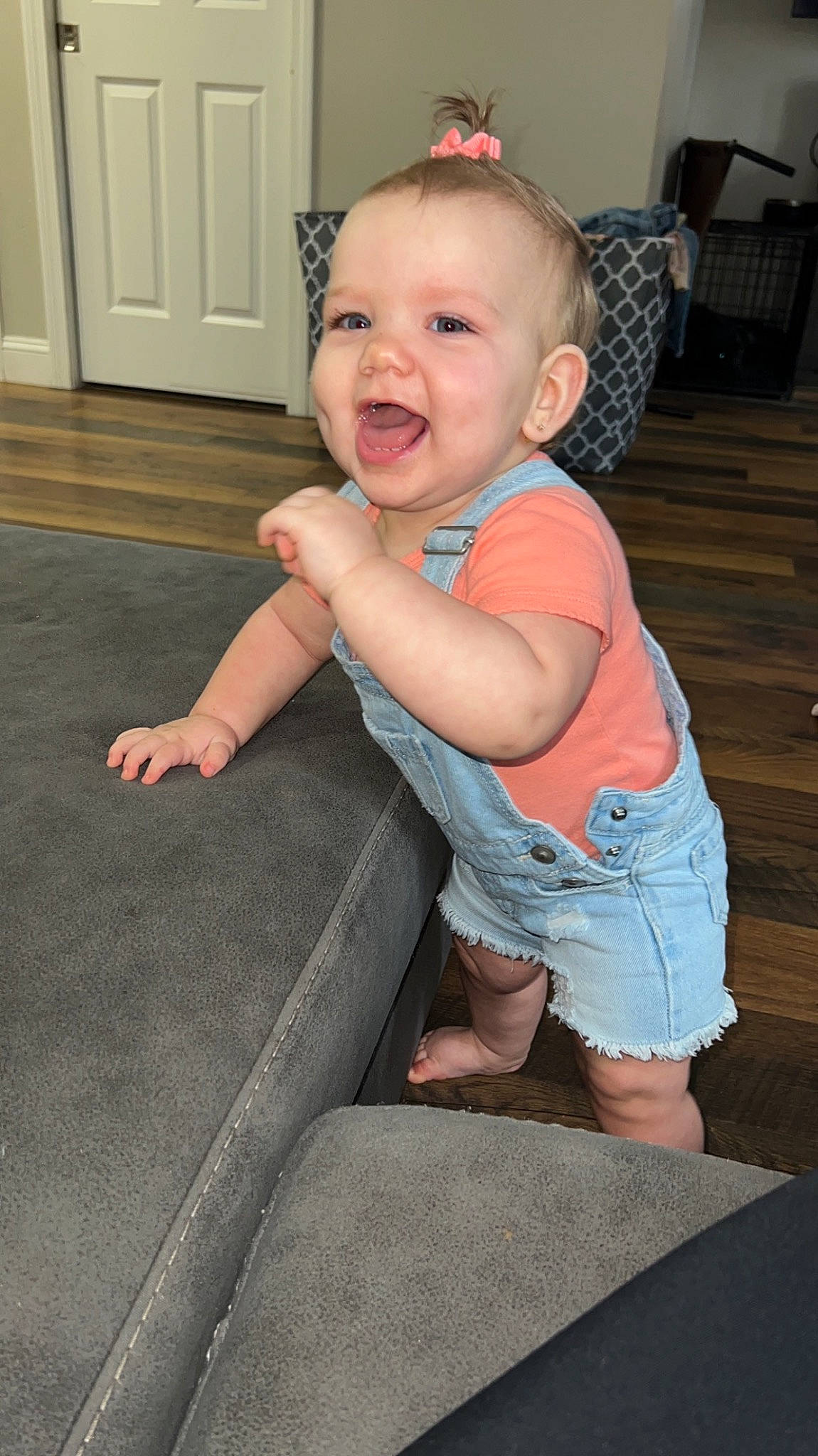 Emersyn is registered to the contest to win money with this photo: baby, baby_toddler_clothing, cheek, child, comfort, door, eye, finger, floor, flooring, fun, hairstyle, head, person, shorts, skin, sleeve, smile, standing, t_shirt
