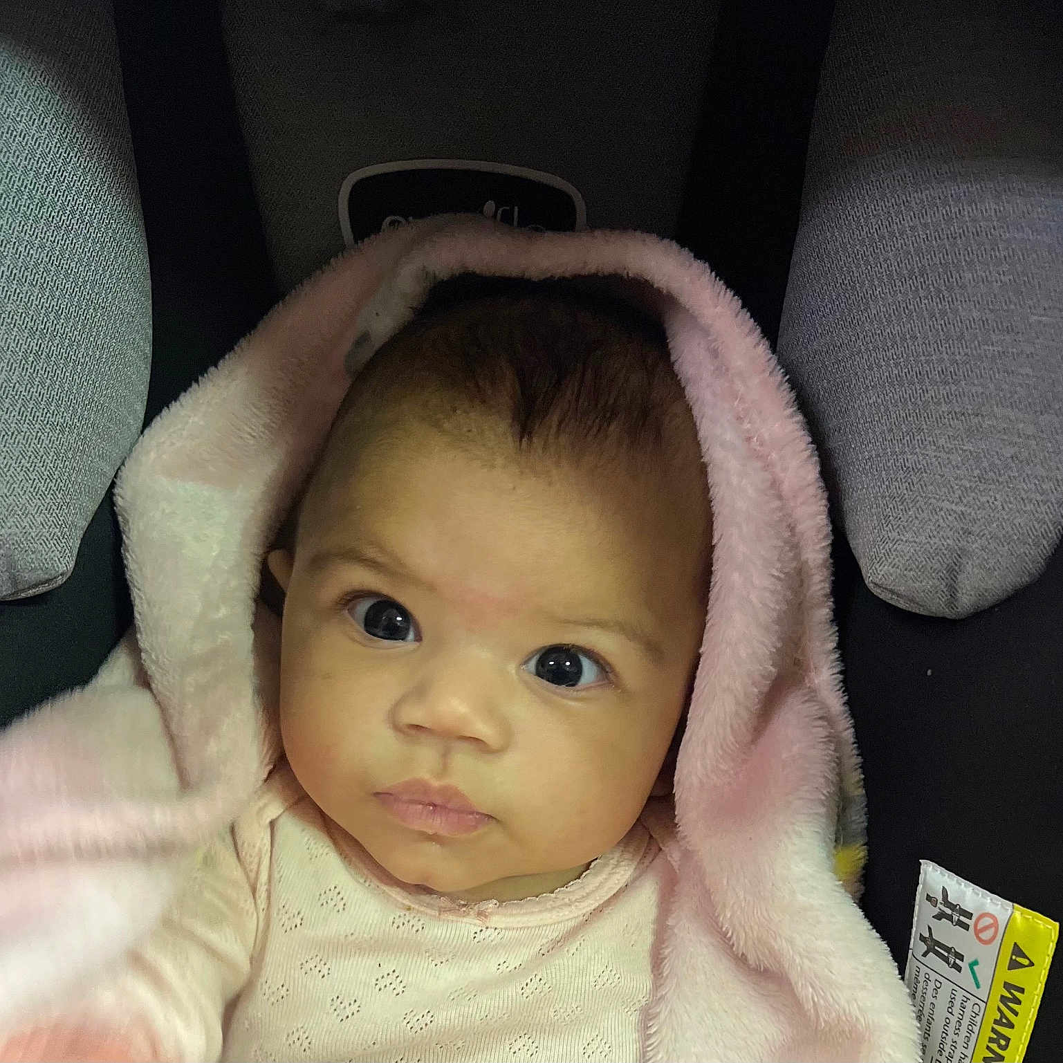 Eudoxa is registered to the contest to win money with this photo: baby, blanket, car, car_interior, carseat, clothing, cushion, face, happy, hat, head, homedecor, hood, newborn, person, photography, portrait, smile, transportation, vehicle