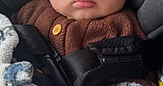 Itai is registered to the contest to win money with this photo: baby, blanket, brown_sweater, car, car_seat, child, cozy, cute, expression, eyes, face, indoor, infant, knit_hat, patterned_blanket, portrait, safety_strap, seatbelt, warm_clothing, young