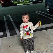 Mateo joined the competition — help win amazing prizes! toddler, child, smiling, mickey_mouse, sweater, checkered_pants, sneakers, sidewalk, night, parking_lot, car, fence, holding_phone, person, outdoor, happy, clothing, fashion, casual, urban