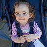 baby, baby_girl, casual_wear, child, curly_hair, cute, daylight, face, hair_tie, happy, outdoor, person, pink_clothing, portrait, seatbelt, sitting, smile, stroller, toddler, young_child