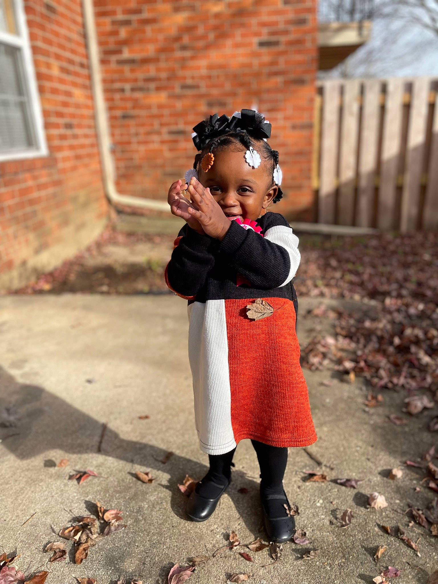 Brielle is registered to the contest to win money with this photo: brick, child, eyewear, fashion_accessory, fawn, flooring, formal_wear, fur, grass, happy, jewellery, pattern, people_in_nature, person, street, suit, toddler, tradition, window, winter