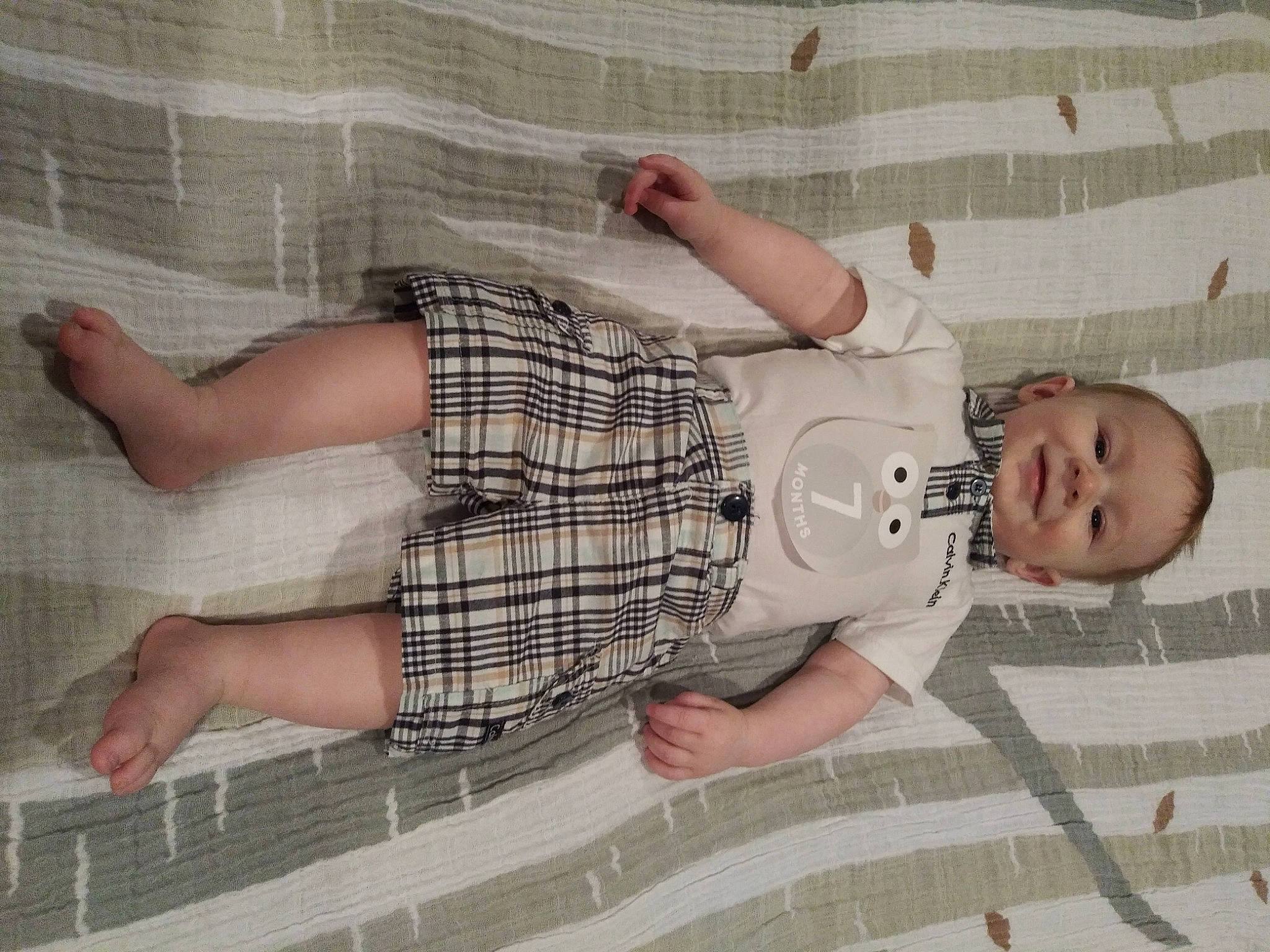 Damian joined the competition — help win amazing prizes! arm, baby, baby_toddler_clothing, child, comfort, finger, flooring, foot, head, human_leg, joint, joy, knee, leg, linens, pattern, person, product, room, textile