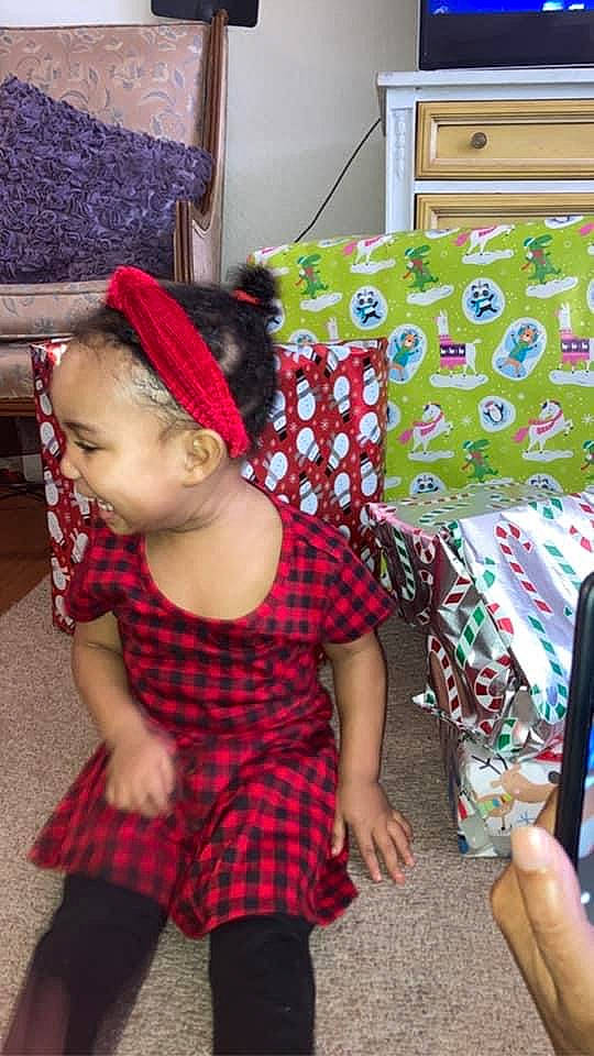 Ximena is registered to the contest to win money with this photo: baby_toddler_clothing, child, event, fun, happy, holiday, human_leg, living_room, magenta, pattern, person, picture_frame, plaid, play, room, sleeve, sock, tartan, textile, thigh