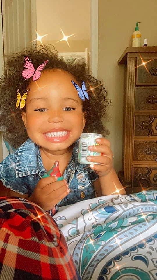 Ximena is registered to the contest to win money with this photo: black_hair, cabinetry, chair, child, cool, eyelash, fashion_accessory, fun, hairstyle, happy, headband, headpiece, joy, long_hair, pattern, person, plaid, room, smile, t_shirt