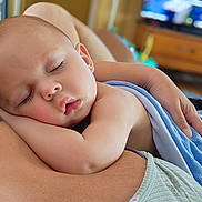 Richmond is registered to the contest to win money with this photo: baby, sleeping, blanket, arm, skin, face, peaceful, child, indoor, person, comfort, rest, nap, closeup, soft, human, parent, holding, relaxation, toddler