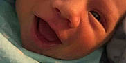 Kizer is registered to the contest to win money with this photo: baby, newborn, smiling, blanket, blue_blanket, face, infant, wrapped, cute, happy, child, portrait, closeup, soft, cozy, sleeping, young, skin, head, expression
