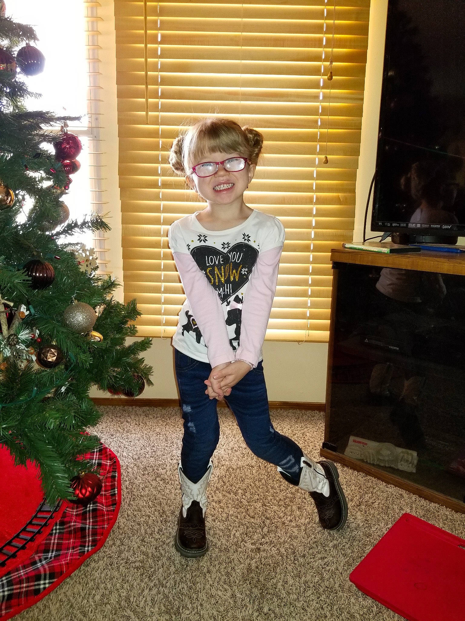 Mahlia is registered to the contest to win money with this photo: child, christmas, christmas_decoration, christmas_eve, christmas_tree, cool, costume, event, footwear, holiday, interior_design, joy, person, shoe, standing, toddler, tree