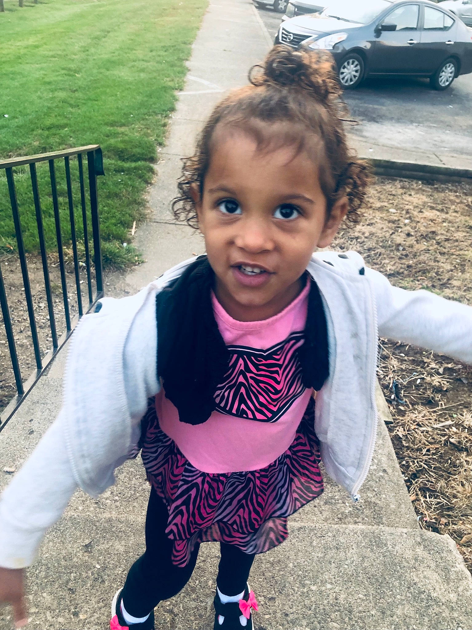 Aniya is registered to the contest to win money with this photo: automotive_tire, baby_toddler_clothing, car, cool, dress, eye, fun, grass, hair, happy, head, leisure, person, plant, smile, snapshot, tire, toddler, tree, vehicle