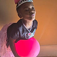 Tevaeh is registered to the contest to win money with this photo: accessories, balloon, child, clothing, dress, face, female, footwear, girl, head, jewelry, necklace, person, photography, portrait, purple, shoe, sphere, tiara, wood