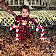 Cayden joined the competition — help win amazing prizes! toddler, child, pajamas, red_and_black, bear_design, candy_cane, lights, autumn_leaves, fence, tattooed_arm, nighttime, outdoor, holiday_decor, person, smiling, curly_hair, supporting_hand, festive, cozy, cute