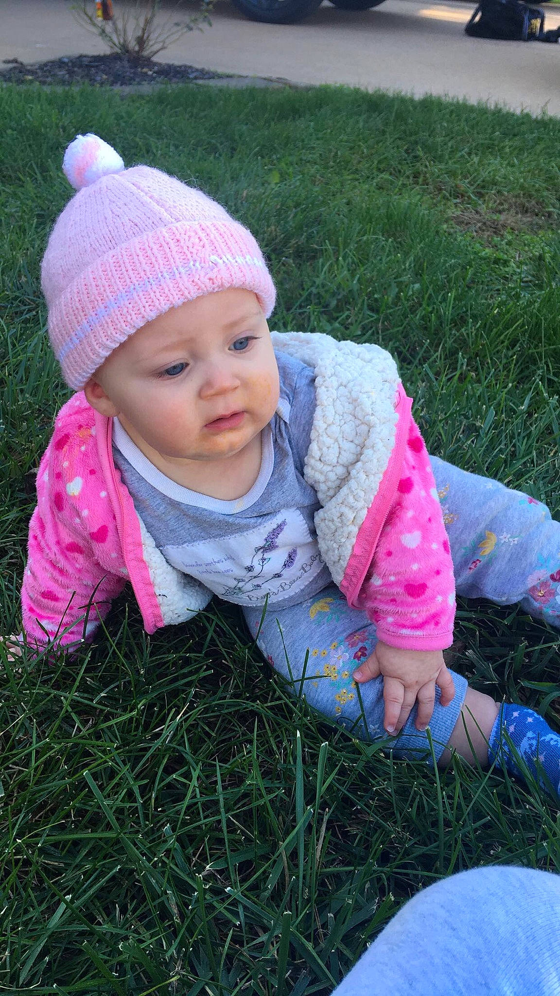 Adalene joined the competition — help win amazing prizes! baby, baby_toddler_clothing, cap, child, face, facial_expression, fun, grass, grass_family, happy, headwear, knit_cap, lawn, magenta, pattern, people_in_nature, person, pink, plant, sitting