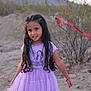 bushes, casual, child, desert, dress, girl, happy, long_hair, nature, outdoor, person, playful, portrait, purple, red_tape, sand, smile, standing, sunset_light, young