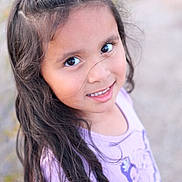Gabriella is registered to the contest to win money with this photo: child, girl, portrait, smile, long_hair, outdoor, purple_shirt, princess_print, face, cute, young, happy, looking_up, natural_light, closeup, casual_clothing, childhood, person, youth, friendly