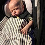 baby, sleeping, blanket, striped, car_seat, infant, child, peaceful, cute, hand, face, clothing, soft_light, indoors, portrait, young_child, resting, cozy, newborn, toddler
