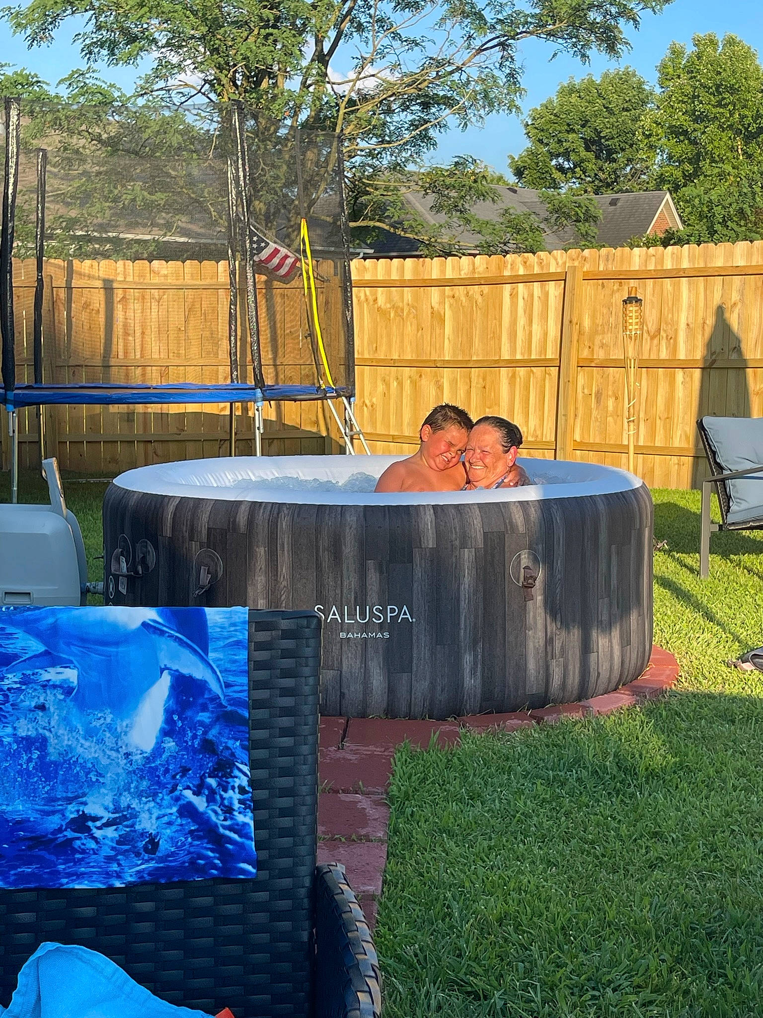 Braxton is registered to the contest to win money with this photo: blue, composite_material, grass, groundcover, home_fencing, joy, landscape, leisure, outdoor_furniture, person, plant, property, recreation, rectangle, shade, shrub, sky, swimming_pool, tree, wall