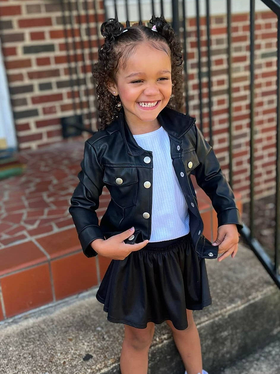 Taelyn is registered to the contest to win money with this photo: blackhair, blazer, child, clothing, coat, curlyhair, dimples, face, female, girl, hair, happy, head, jacket, person, skirt, sleeve, smile, standing, student