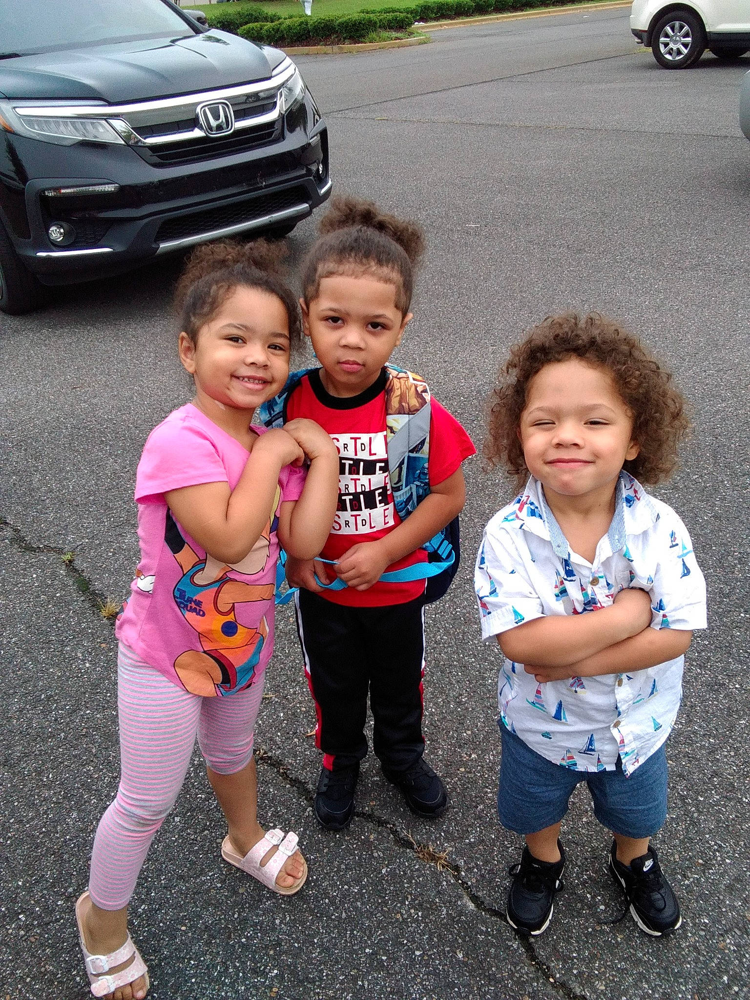 Raelynn is registered to the contest to win money with this photo: asphalt, automotive_design, automotive_exterior, automotive_lighting, automotive_tire, car, footwear, grille, happy, joy, leisure, motor_vehicle, person, personal_luxury_car, shoe, smile, sneakers, t_shirt, tire, toddler