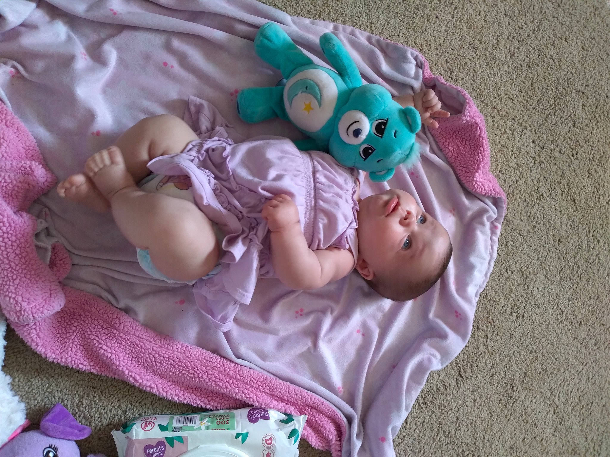Cheyenne joined the competition — help win amazing prizes! baby, baby_products, baby_toddler_clothing, child, comfort, doll, dress, fashion_accessory, grass, hand, linens, magenta, pattern, person, pink, purple, sitting, skin, sleeve, toddler