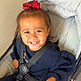 Ophelia joined the competition — help win amazing prizes! toddler, child, smiling, red_bow, stroller, seatbelt, cute, happy, indoors, clothing, person, face, hair, baby, young_child, safety_harness, candid, portrait, infant, joyful