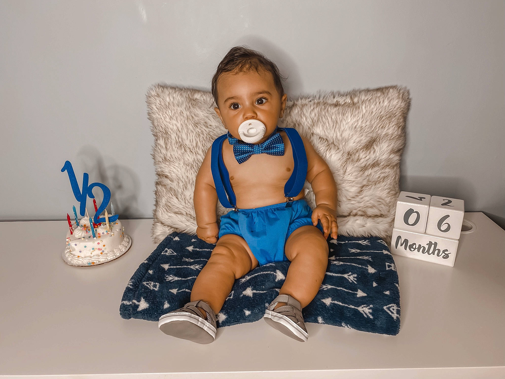 Cristiano is registered to the contest to win money with this photo: baby, baby_toddler_clothing, child, footwear, person, room, shoe, sitting, toddler
