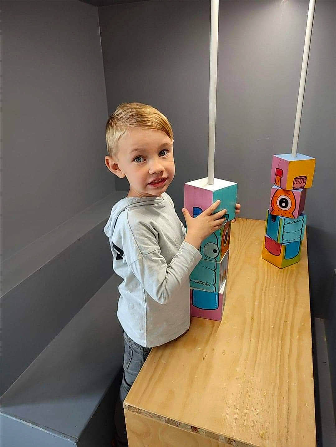 Raphael participe au concours pour gagner de l'argent avec cette photo : baby, child, desk, flooring, fun, hardwood, paint, person, play, plywood, room, sleeve, smile, t_shirt, table, thumb, toddler, varnish, wood, wood_stain