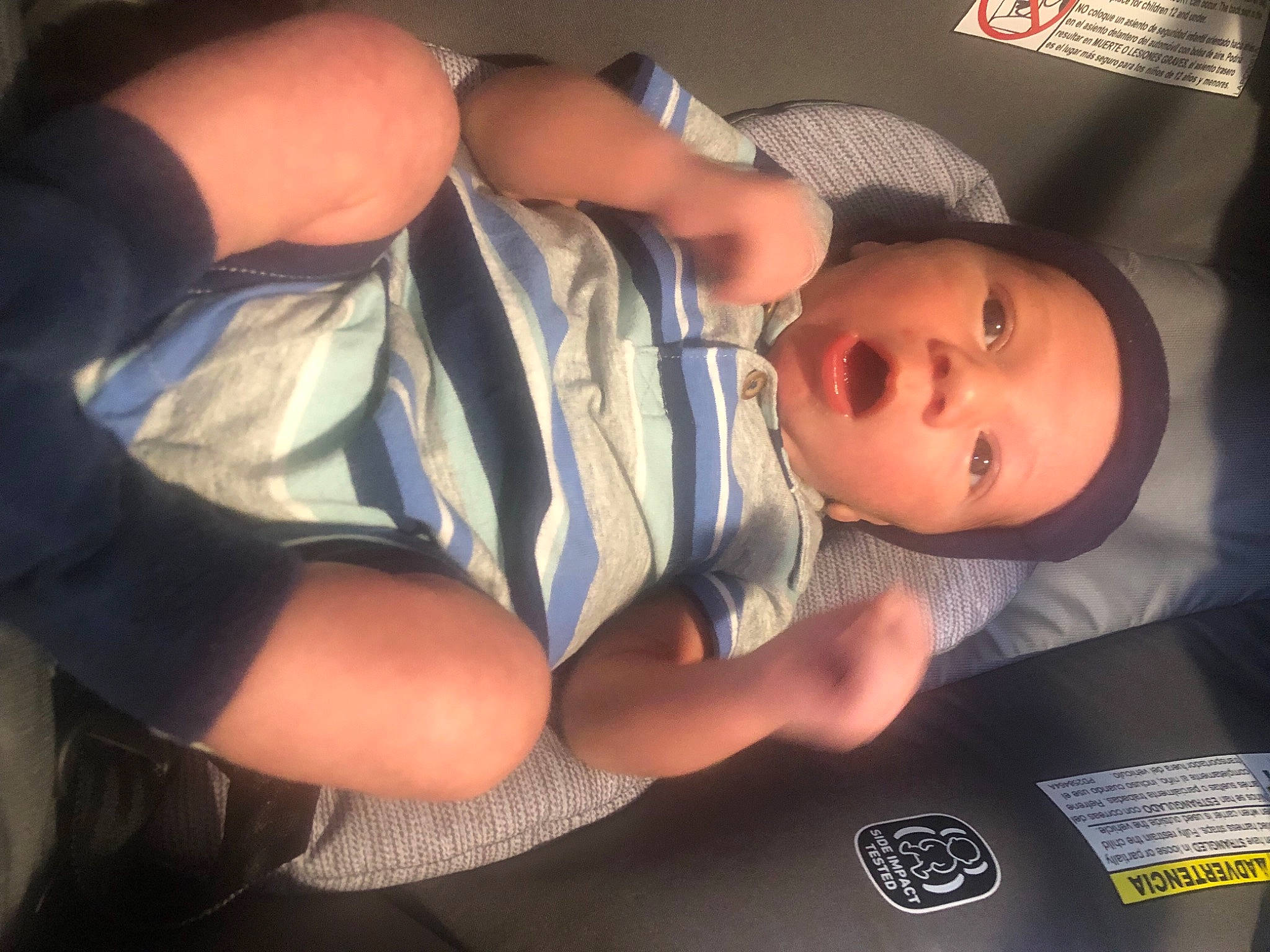 Emilio is registered to the contest to win money with this photo: arm, baby, baby_toddler_clothing, chest, child, comfort, elbow, finger, fun, gesture, hand, hat, headwear, human_leg, mouth, nail, nose, person, skin, thumb