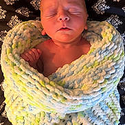 Nico Clyde is registered to the contest to win money with this photo: baby, bed, bedding, blanket, closeup, cozy, hand, indoor, infant, newborn, paisley_pattern, peaceful, plush_blanket, portrait, resting, skin, sleeping, soft_texture, swaddled, wrapped
