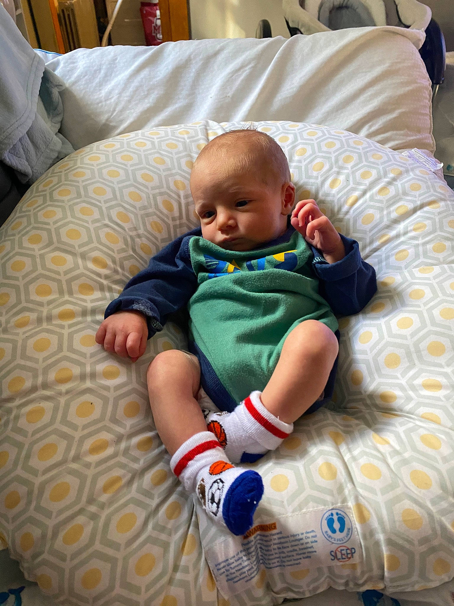 Beau is registered to the contest to win money with this photo: baby, baby_products, baby_toddler_clothing, child, comfort, couch, eye, fun, furniture, head, lap, linens, living_room, person, play, product, room, sitting, skin, textile