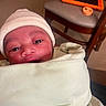 Jacory is registered to the contest to win money with this photo: baby, infant, blanket, hat, face, eyes, indoors, chair, tablet, wooden_furniture, cozy, wrapped, curious, soft_texture, headwear, person, portrait, newborn, warm_lighting, closeup