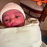 Jacory joined the competition — help win amazing prizes! baby, infant, blanket, hat, face, eyes, wrapped, cozy, indoor, furniture, chair, tablet, orange, curious, cute, soft, newborn, person, portrait, closeup
