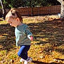 Zaylee is registered to the contest to win money with this photo: toddler, child, outdoor, sunlight, grass, leaves, tree, fence, shadow, sweater, leggings, shoes, person, nature, play, fall, yard, curly_hair, walking, daylight