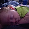 Ethan is registered to the contest to win money with this photo: baby, sleeping, infant, portrait, close_up, indoors, blanket, green_clothing, curled_up, peaceful, resting, face, ear, closed_eyes, soft_lighting, cozy, bed, home, nap, cute
